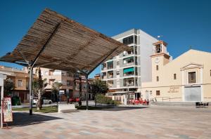 a large pavilion in a city with a building at Sunny Sea in La Mata