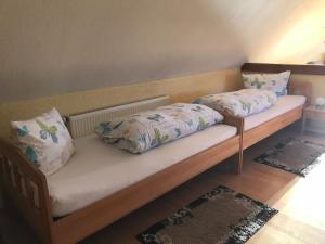 two beds with pillows on them in a room at Urlaub auf dem Bauernhof Zeller in Wolframs-Eschenbach