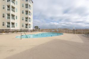 a swimming pool in front of a apartment building at A Place at the Beach by Capital Vacations in Myrtle Beach