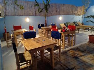 a group of tables and chairs in a room at Riad dar Assou in Marrakesh