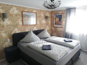 a bed with two pillows on it in a bedroom at Eleonora Apartment in Winterberg