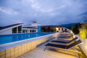 a swimming pool in a villa at night at Regal Hotel in Brescia