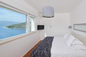 Postel nebo postele na pokoji v ubytování The White House, Brac
