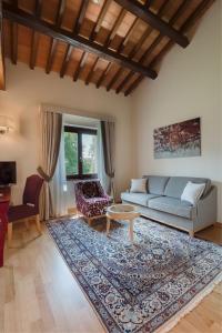 a living room with a couch and a table at Borgo La Chiaracia Resort & SPA in Castel Giorgio