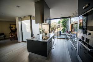 a kitchen with a sink and a counter top at Casa Foz do Corgo - private pool, gardens and river access in Peso da Régua
