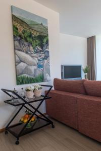 a living room with a couch and a table with fruit on it at Casa Foz do Corgo - private pool, gardens and river access in Peso da Régua