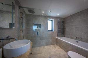 a bathroom with a bath tub and a sink at Oran Na Mara, Waternish in Hallin