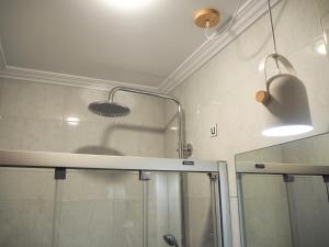 a bathroom with a shower and a glass shower stall at Pensión Urkia in Donostia-San Sebastián +117 photos