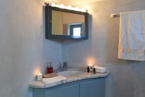 a bathroom sink with two candles and a mirror at Eagles Nest in Angairiá