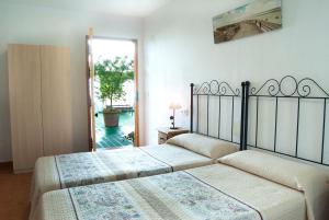 Postel nebo postele na pokoji v ubytování Hostal Batato