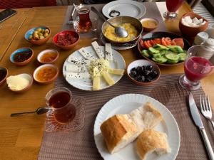 a table with plates of bread and bowls of food at Ada Residence in Kahramanmaraş