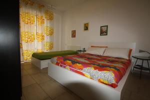 a bedroom with a bed and a table and curtains at Appartamenti Giusy e Giusy 2 in Sorrento