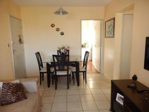 a dining room and living room with a table and chairs at APTº EM OLINDA CASA CAIADA in Olinda