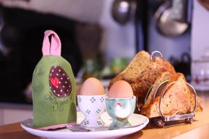 a table with eggs and bread on a plate at Brook Farmhouse in Exeter