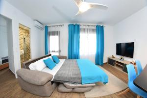 a bedroom with a bed and a chair and a television at Zenbeach 1A playa carihuela in Torremolinos