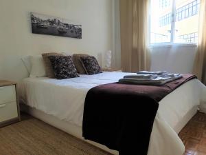 a bedroom with a bed with towels on it at Invicta Flats - Oporto in Porto