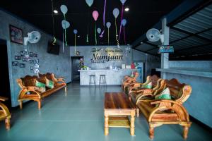 a restaurant with couches and a table and a bar at Numjaan Resort in Krabi town