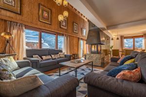 a large living room with couches and a fireplace at Chalet Zebra in Méribel