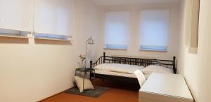 a small bedroom with a bed and two windows at Hotel Kronberg in Kronberg im Taunus