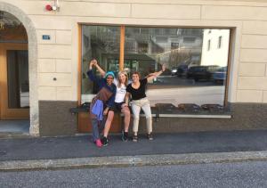 three women posing for a picture in front of a window at Bed&Bike Tremola San Gottardo in Airolo
