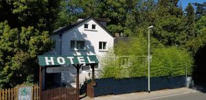 a white building with a hotel sign in front of it at Hotel Kronberg in Kronberg im Taunus