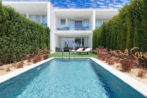 a swimming pool in front of a house at Sao Rafael Holidays in Albufeira