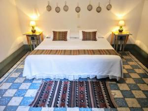 a bedroom with a large bed with two night stands at El Diablo y la Sandia B&B in Oaxaca City