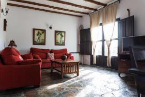 uma sala de estar com um sofá vermelho e uma mesa em Casa La Viña em Pedroso de Acim