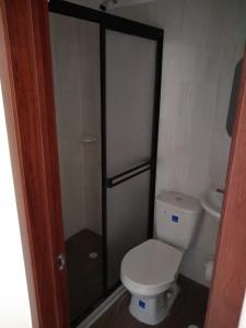 a small bathroom with a toilet and a shower at Hotel Don Luis in Ocaña