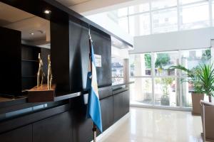 a lobby with a flag on a black wall at Hotel 6 de Octubre in Buenos Aires
