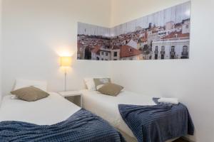 מיטה או מיטות בחדר ב-4U Alojamento - Jardim