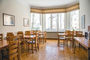 an empty dining room with tables and chairs at Villa Kaunensis in Kaunas