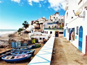 a group of boats parked next to a beach at Taghazout Bay Appartement Agadir in Tamraght Oufella