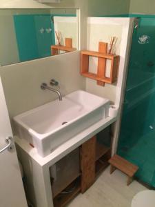 a bathroom with a white sink and a shower at Blu Klein in Foligno