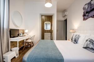 En eller flere senger på et rom på Loulé Coreto Guesthouse