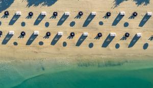 an aerial view of a group of chairs on the beach at Naples Grande Beach Resort in Naples