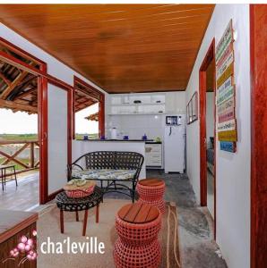 a kitchen with a table and some chairs and a counter at Chale´Ville Charme 902 in Luis Correia