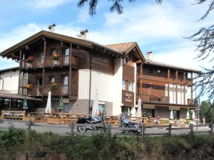 a building with a motorcycle parked in front of it at DOLOMITI appart&rooms in Varena
