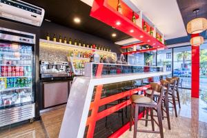 a bar with stools and a counter with drinks at Swans Cay Hotel in Bocas del Toro