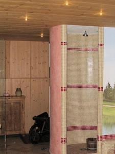 a room with a pillar and a motorcycle in it at DOLOMITI appart&rooms in Varena