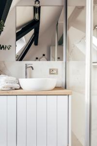a bathroom with white cabinets and a sink at Maison Francois in Varsenare