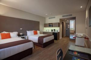 Krevet ili kreveti u jedinici u objektu Paseo La Galería Hotel & Suites