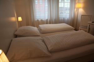 Säng eller sängar i ett rum på Hotel Seepromenade