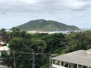 a view of a small island in the distance at Paraíso do Santinho Apartamentos in Florianópolis