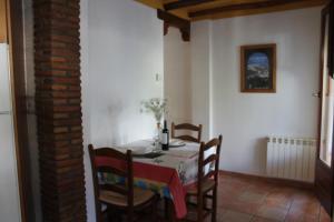 a dining room with a table and some chairs at La Tila in Capileira