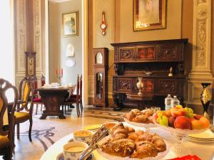 a table with a bunch of food on it at Charme of Villa Capannina in Novi Ligure