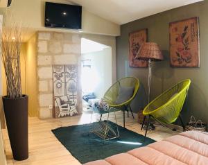sala de estar con sillas verdes y sofá en Mas Guiraud, le Coquet, en Beaucaire