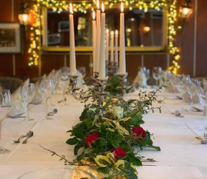 a long table with candles and flowers on it at Sohre in Hamburg