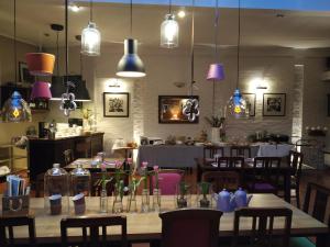 a dining room with tables and chairs and lights at Hotel Stare Miasto Old Town in Poznań