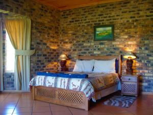 A bed or beds in a room at Thaba Tsweni Lodge & Safaris